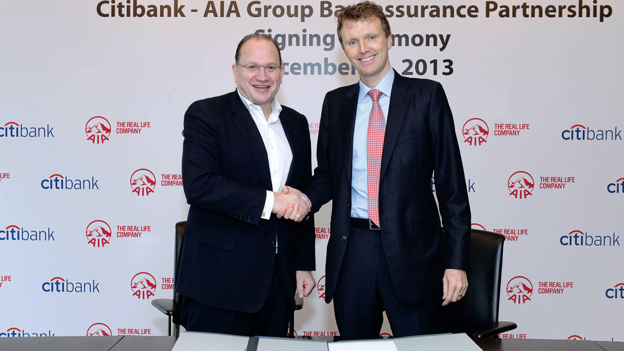 AIA's Mark Tucker shakes hands with Citi's Stephen Bird