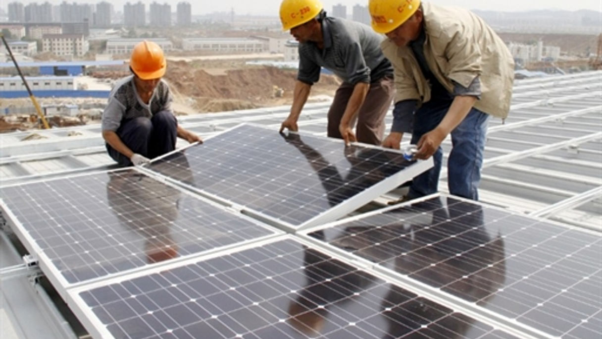 <div style="text-align: left;">
Workers install solar panels on the roof of a railway station in China's Nanjing City. (AFP)</div>