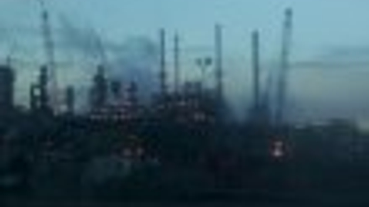 An oil refinery at dawn