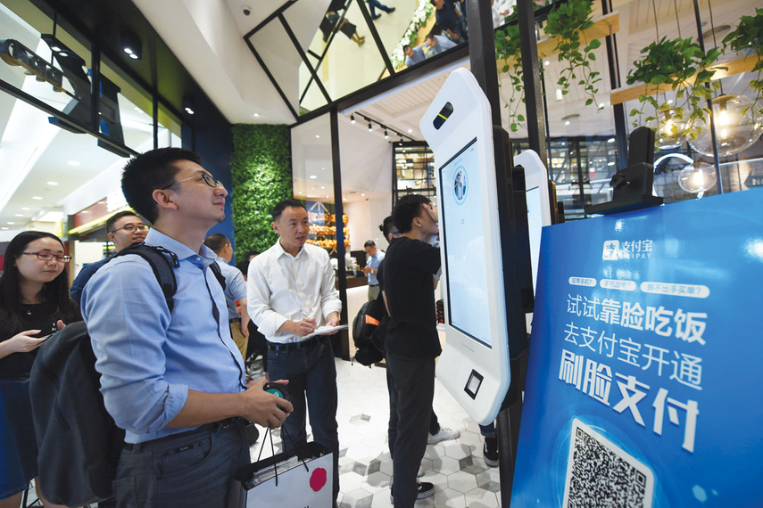 Finger-lickin’ recognition: A customer orders KFC using facial recognition technology at a restaurant in Hangzhou city in September.