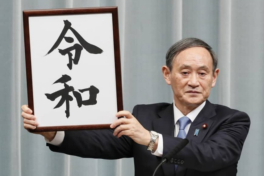 Chief Cabinet Secretary Yoshihide Suga holds up a placard showing the kanji ‘Reiwa’ for the new Imperial era