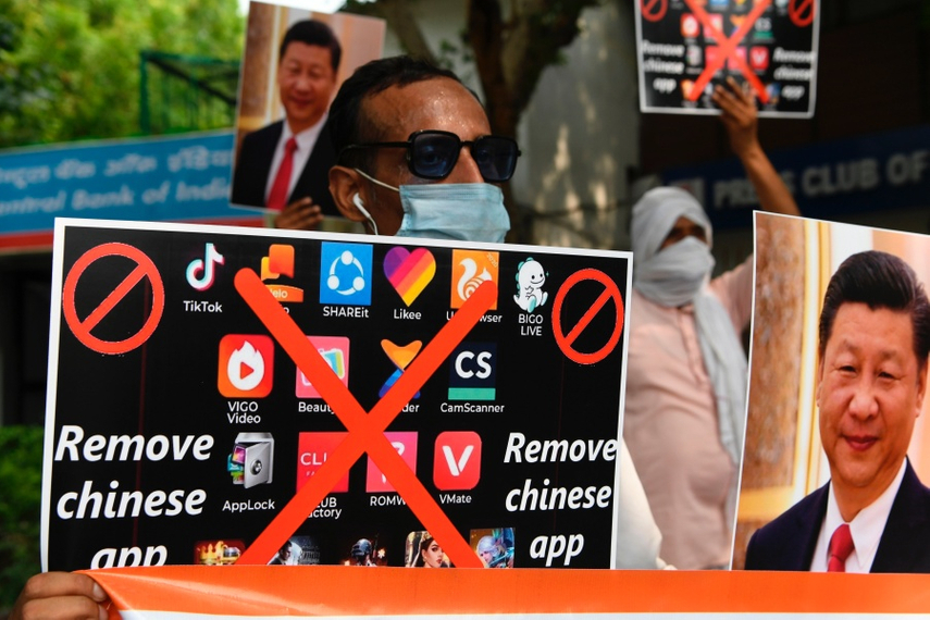 Members of the Working Journalist of India (WJI) hold placards urging citizens to remove Chinese apps during a demonstration against the Chinese newspaper Global Times, in New Delhi on June 30, 2020. Source: Getty Images